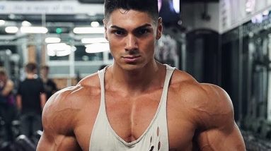 Mean looking body builder in a vest in the gym