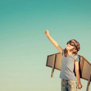 A child with wings looking up at the sky.