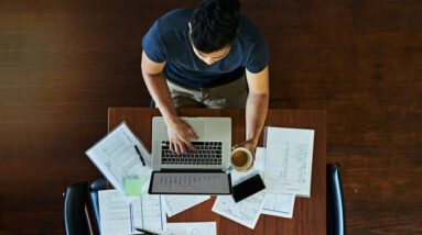 A man working at his desk seen from above.