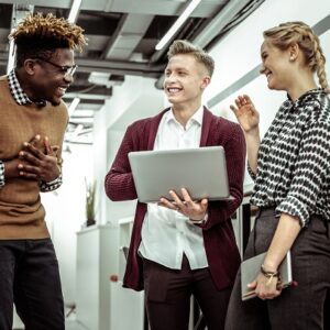 Coworkers in an office laughing about something.