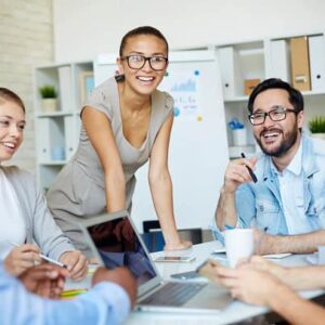 A meeting in the office with people having a good time.