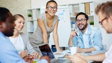 A meeting in the office with people having a good time.