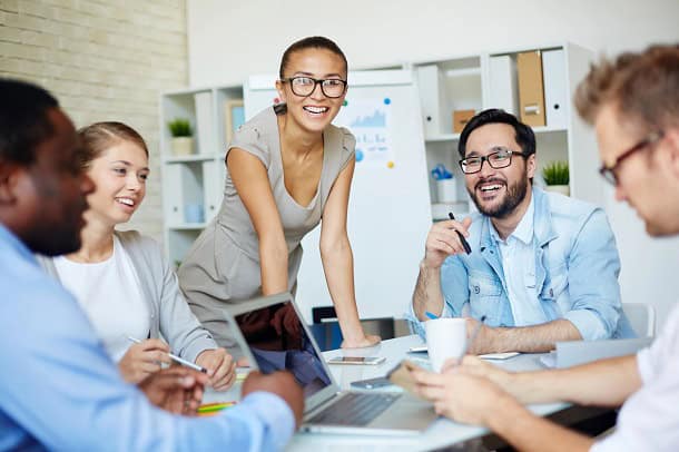 A meeting in the office with people having a good time.