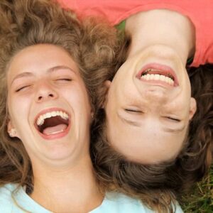 Two friends laughing together.