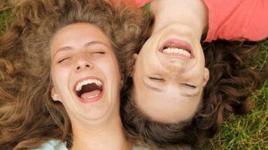 Two friends laughing together.