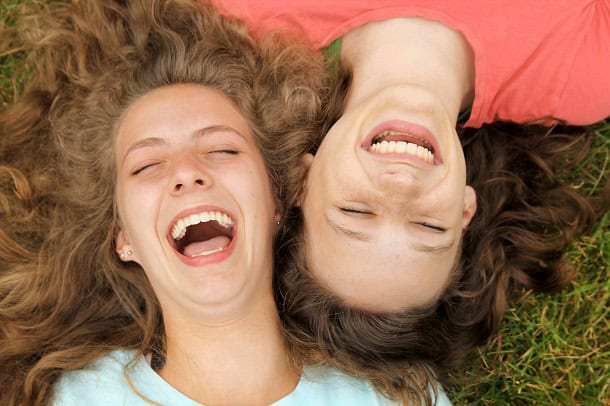 Two friends laughing together.