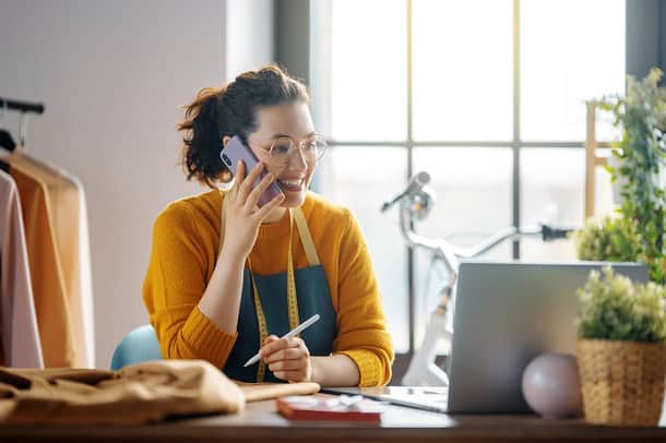 A female small business owner talking on the phone.