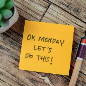 A post-it on a table saying: OK Monday, let's do this!