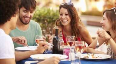 Happy people sharing a meal outside in the warmth.