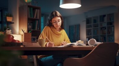 A woman focusing on studying in the evening.