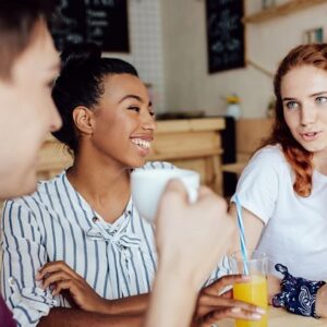 Friends laughing and having fun in a cafe.