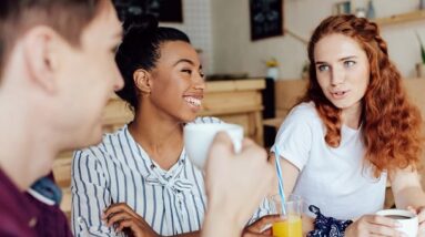 Friends laughing and having fun in a cafe.