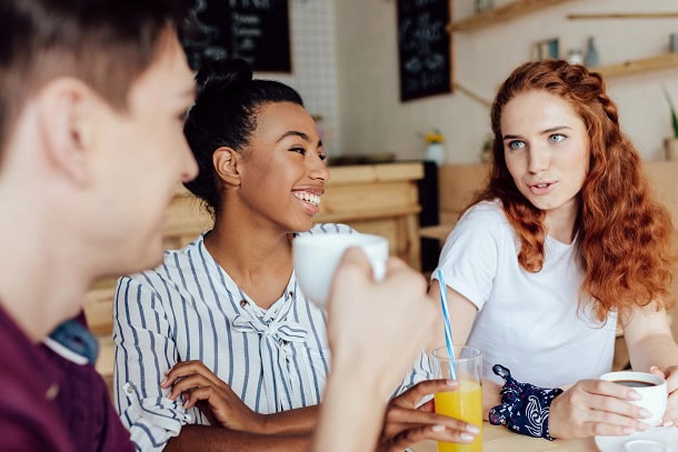 Friends laughing and having fun in a cafe.