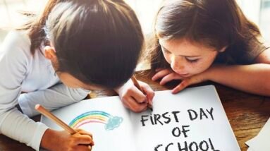 Two girls in school coloring a rainbow and writing: First Day of School.