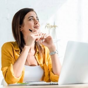 A thoughtful woman at work.
