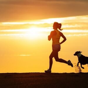 Woman on run in the sun with her dog.