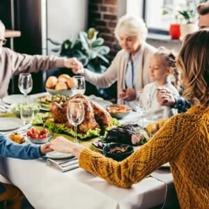 A family saying a prayer before Thanksgiving dinner.
