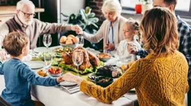 A family saying a prayer before Thanksgiving dinner.