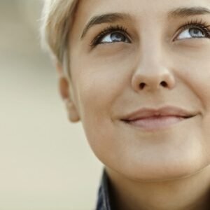 A smiling woman looking up.