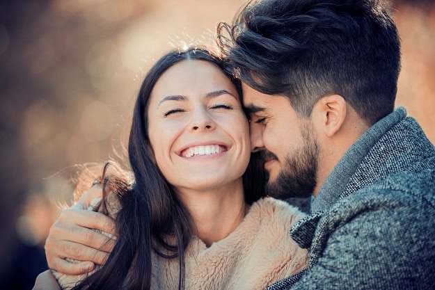 A happy couple in love in a hug.