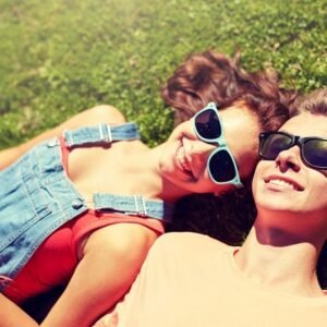 Smiling couple lying in the spring grass.