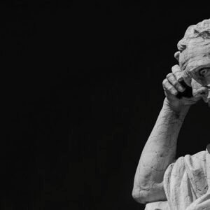 A statue of a man deep in thought.